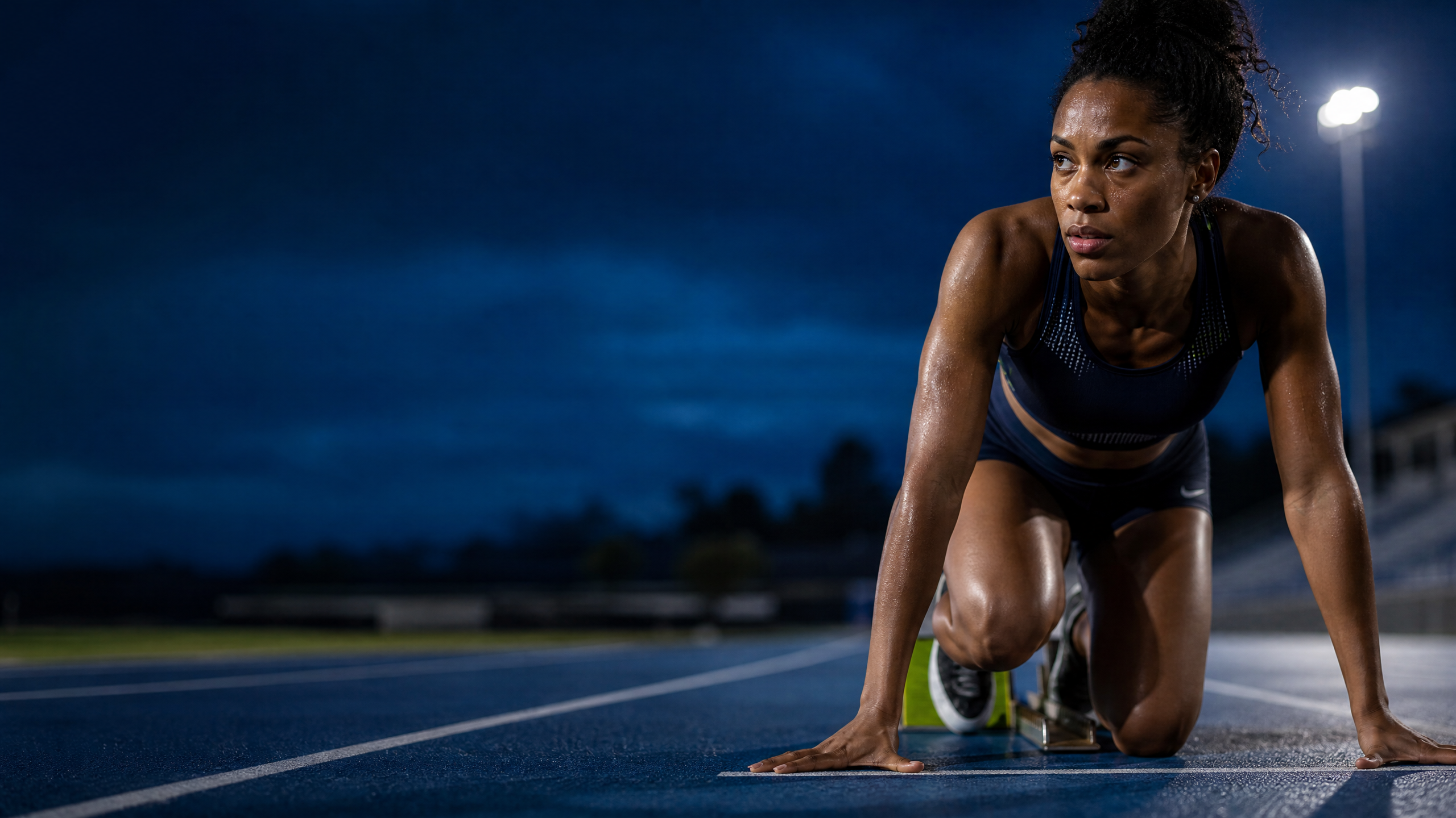 Focused track athlete preparing to sprint
